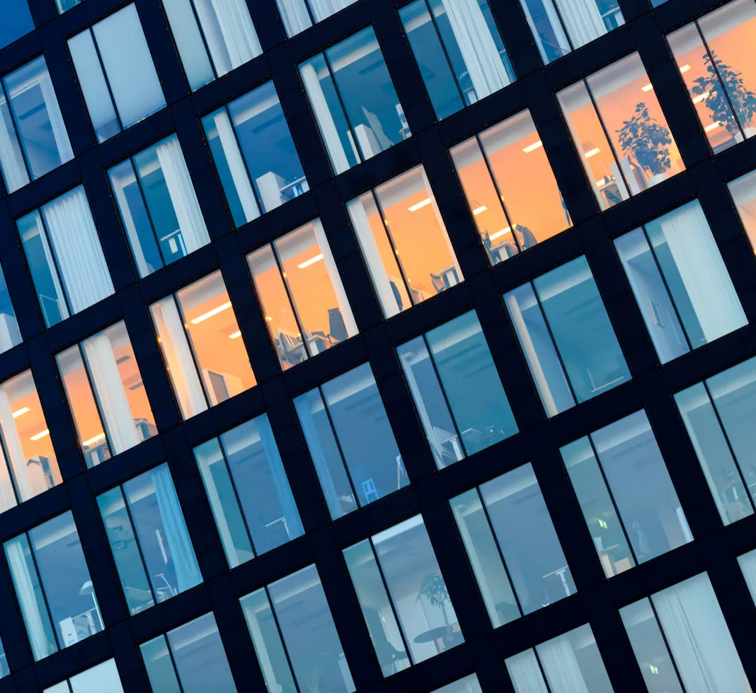 A side of corporate office showing many windows.