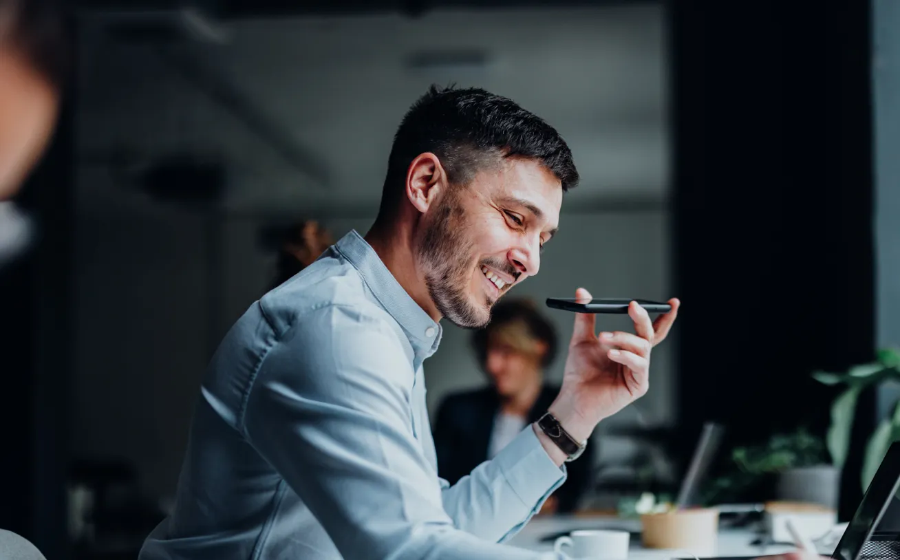 PowerPlan employee speaking to a client partner on a phone.