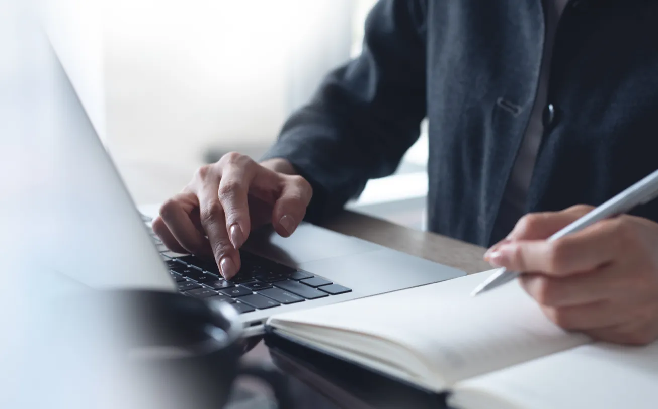 PowerPlan employee working on a laptop.